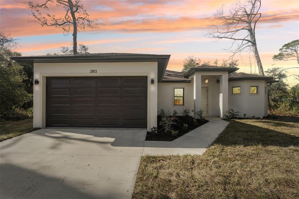 1852 Rada Lane North Port, FL 34288 - Photo 27 of 29 a front view of a house with garden