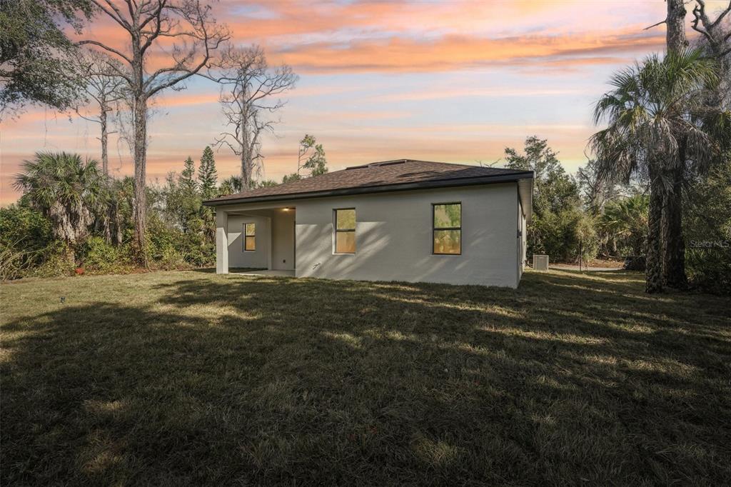 1852 Rada Lane North Port, FL 34288 - Photo 28 of 29 a backyard of a house with lots of green space