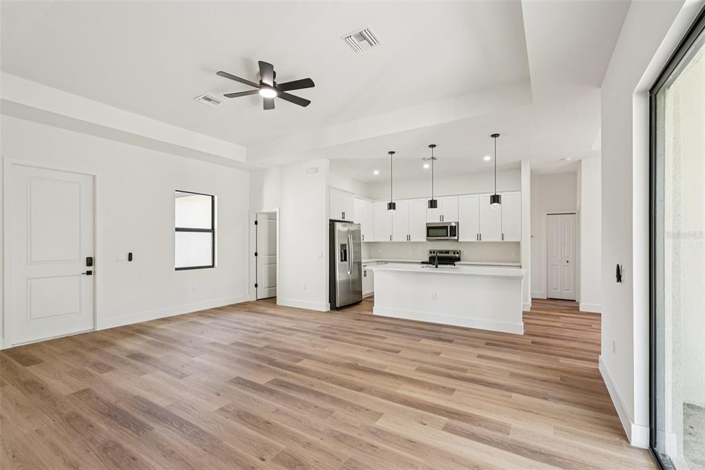 1852 Rada Lane North Port, FL 34288 - Photo 6 of 29 a view of a kitchen with cabinets stainless steel appliances and a ceiling fan