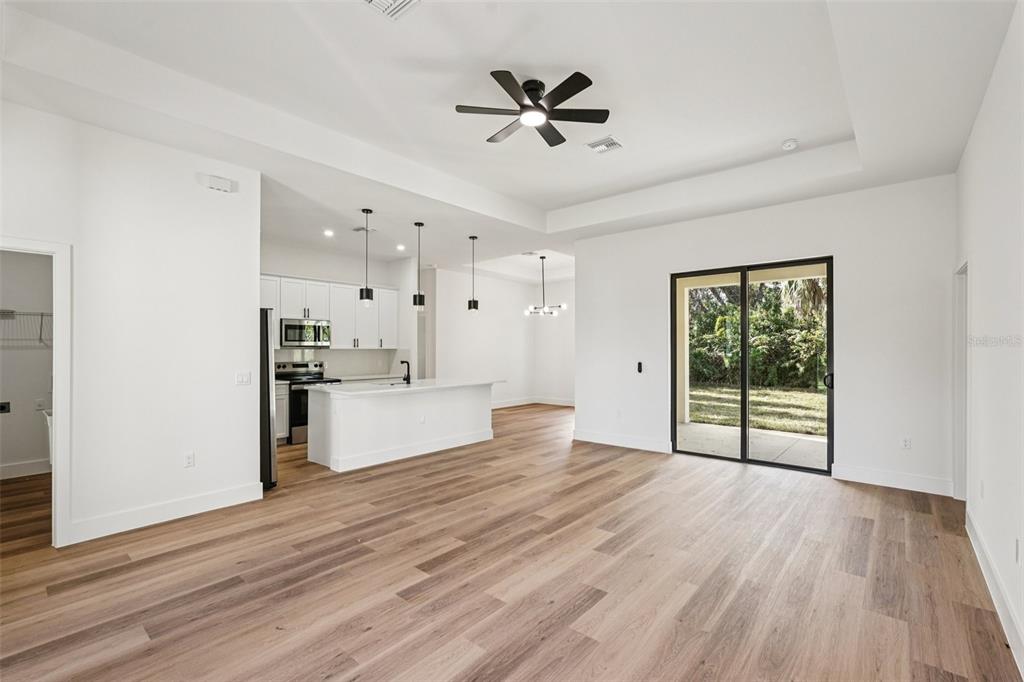 1852 Rada Lane North Port, FL 34288 - Photo 7 of 29 a view of an empty room with a window and wooden floor