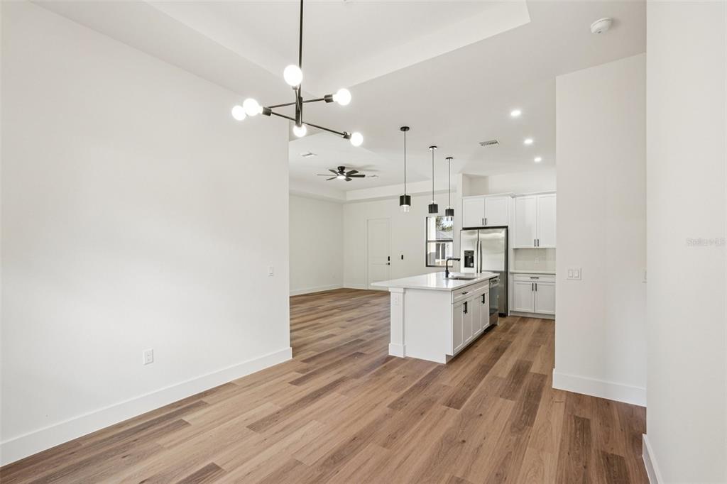 1852 Rada Lane North Port, FL 34288 - Photo 8 of 29 a large kitchen with a white stove top oven and cabinets
