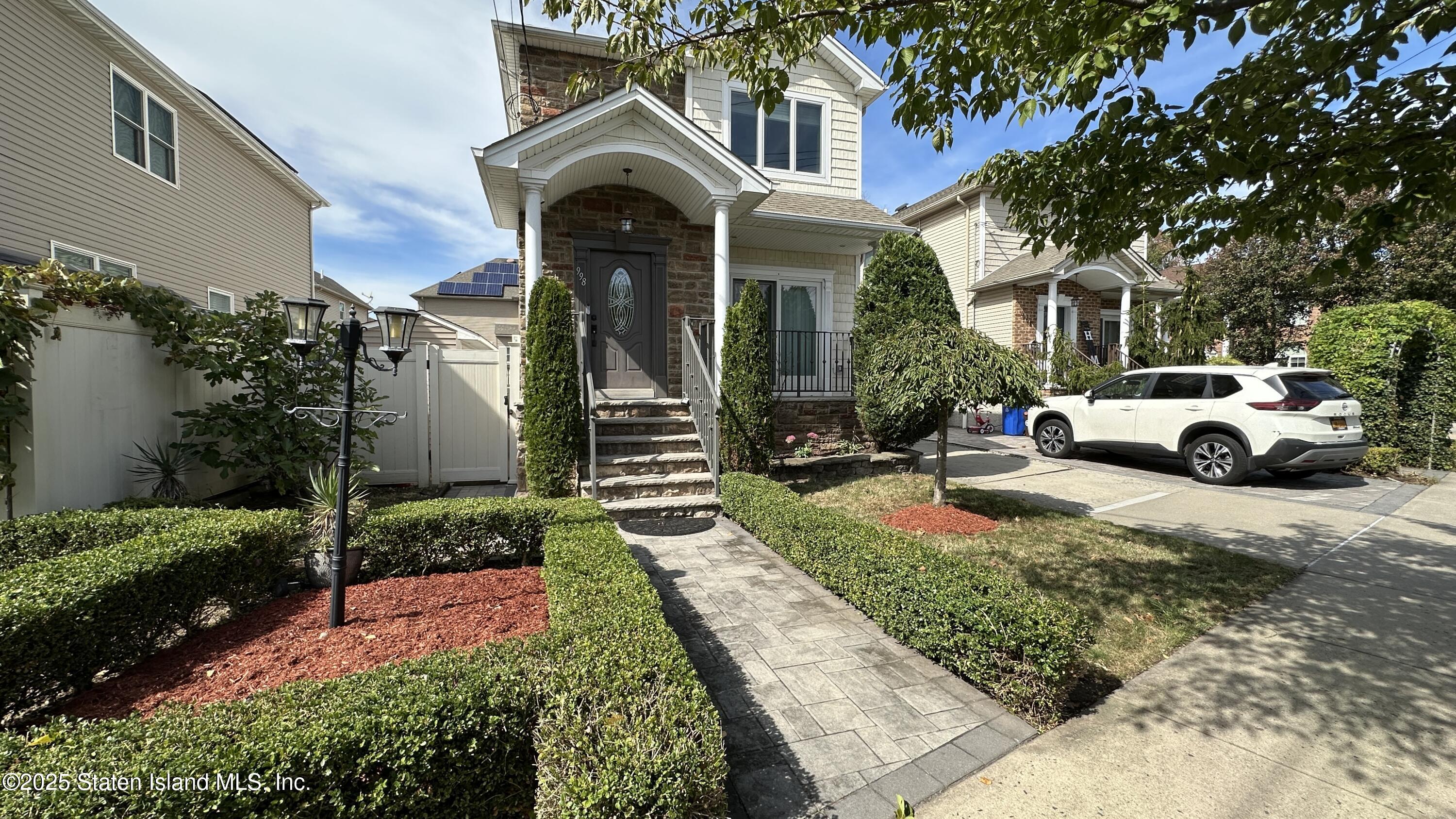 a front view of a house with garden