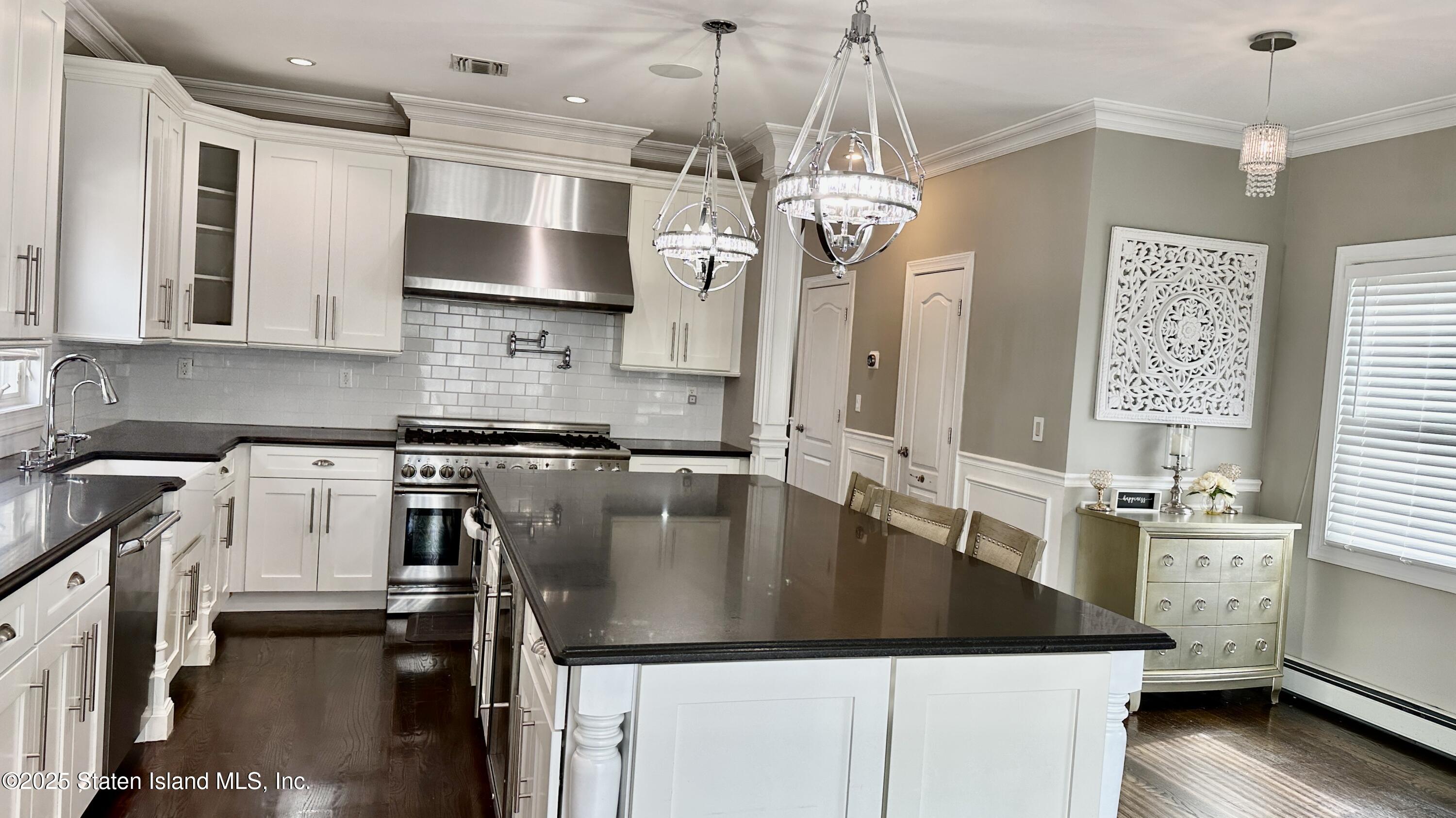 998 Annadale Road Staten Island, NY 10312 - Photo 12 of 46 a kitchen with stainless steel appliances granite countertop a sink a stove and a refrigerator