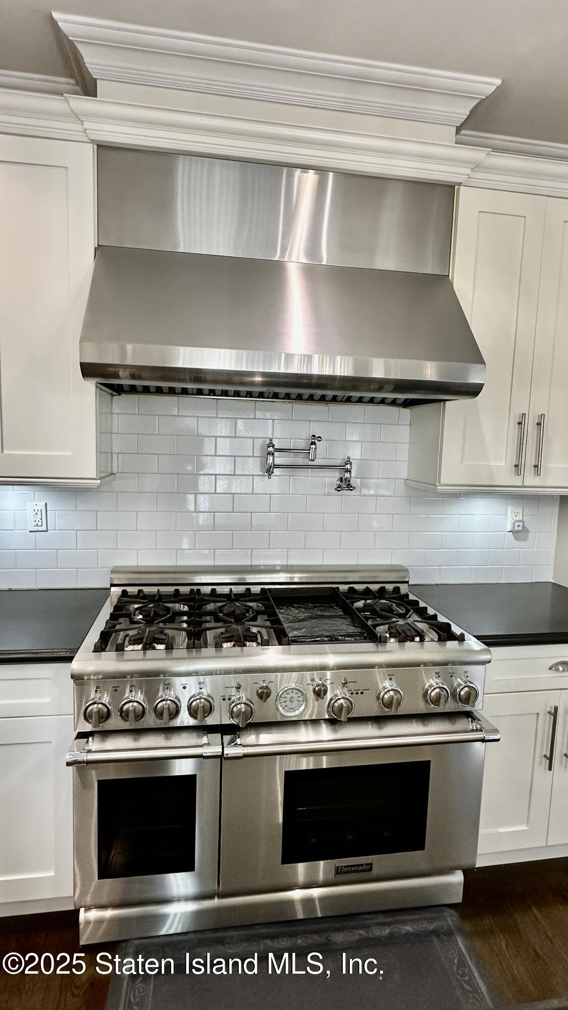 998 Annadale Road Staten Island, NY 10312 - Photo 13 of 46 a stove top oven sitting inside of a kitchen