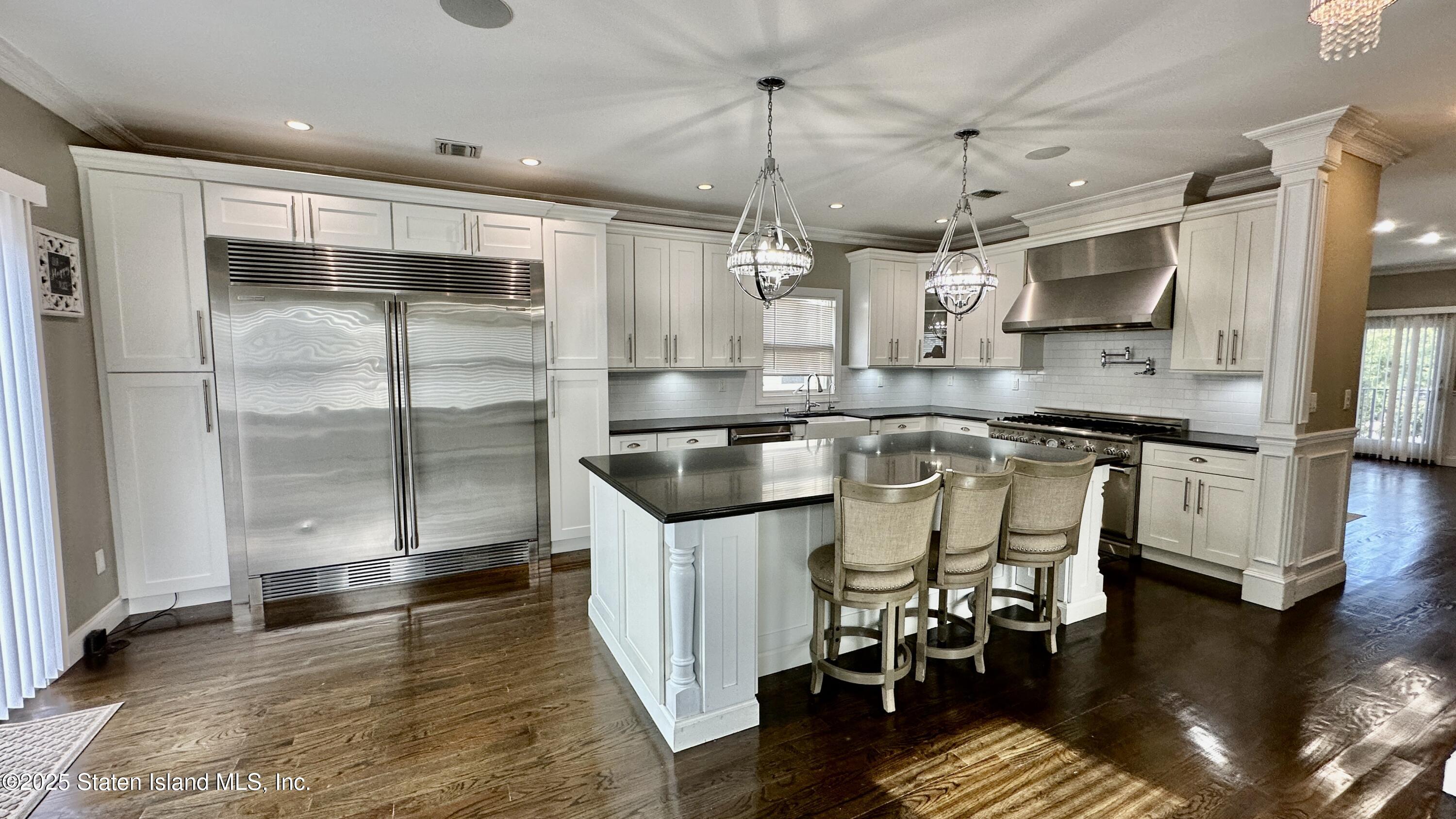 998 Annadale Road Staten Island, NY 10312 - Photo 16 of 46 a kitchen with stainless steel appliances granite countertop a sink a stove and a refrigerator