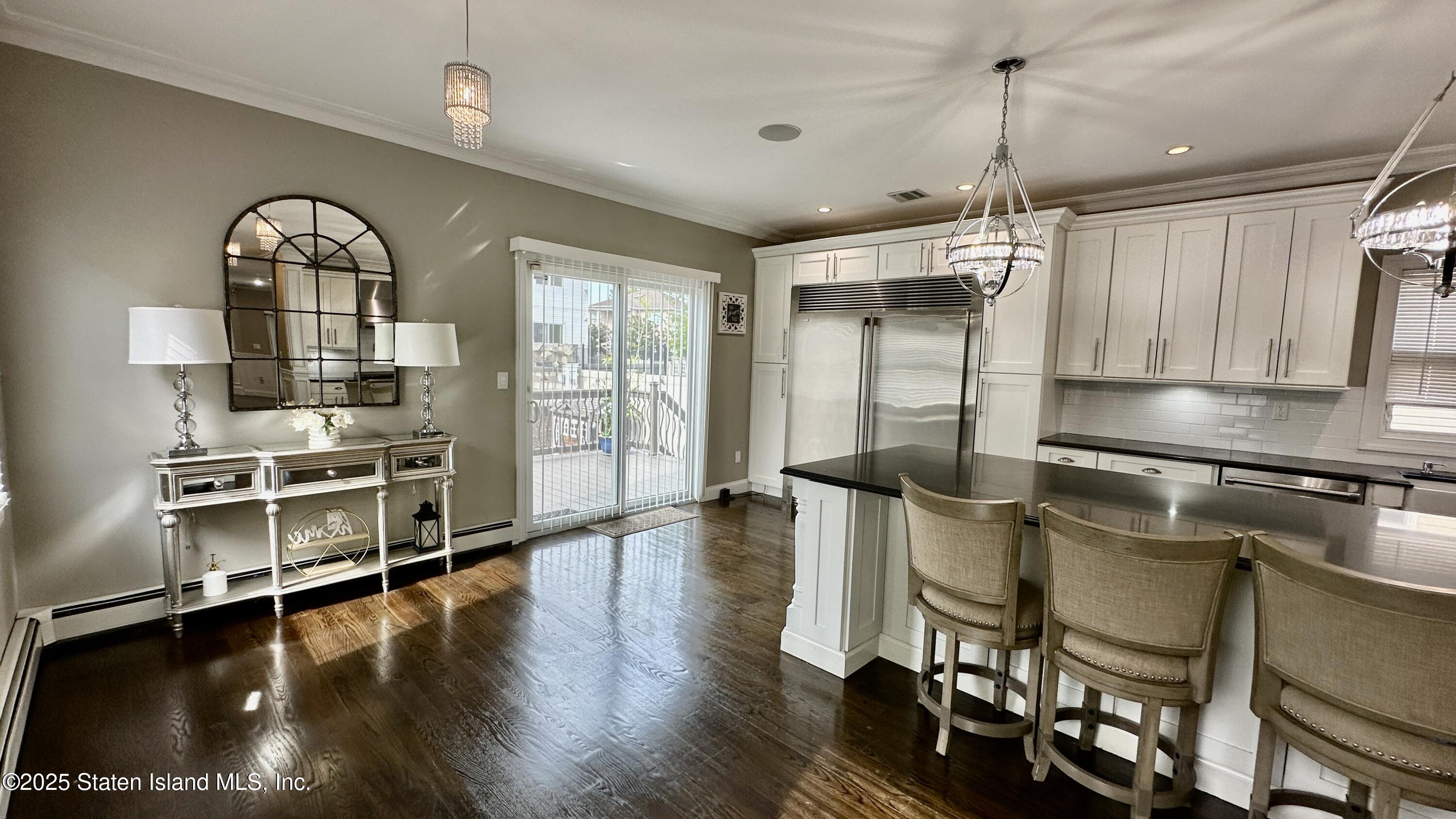 998 Annadale Road Staten Island, NY 10312 - Photo 17 of 46 a view of a kitchen with fridge and wooden floor