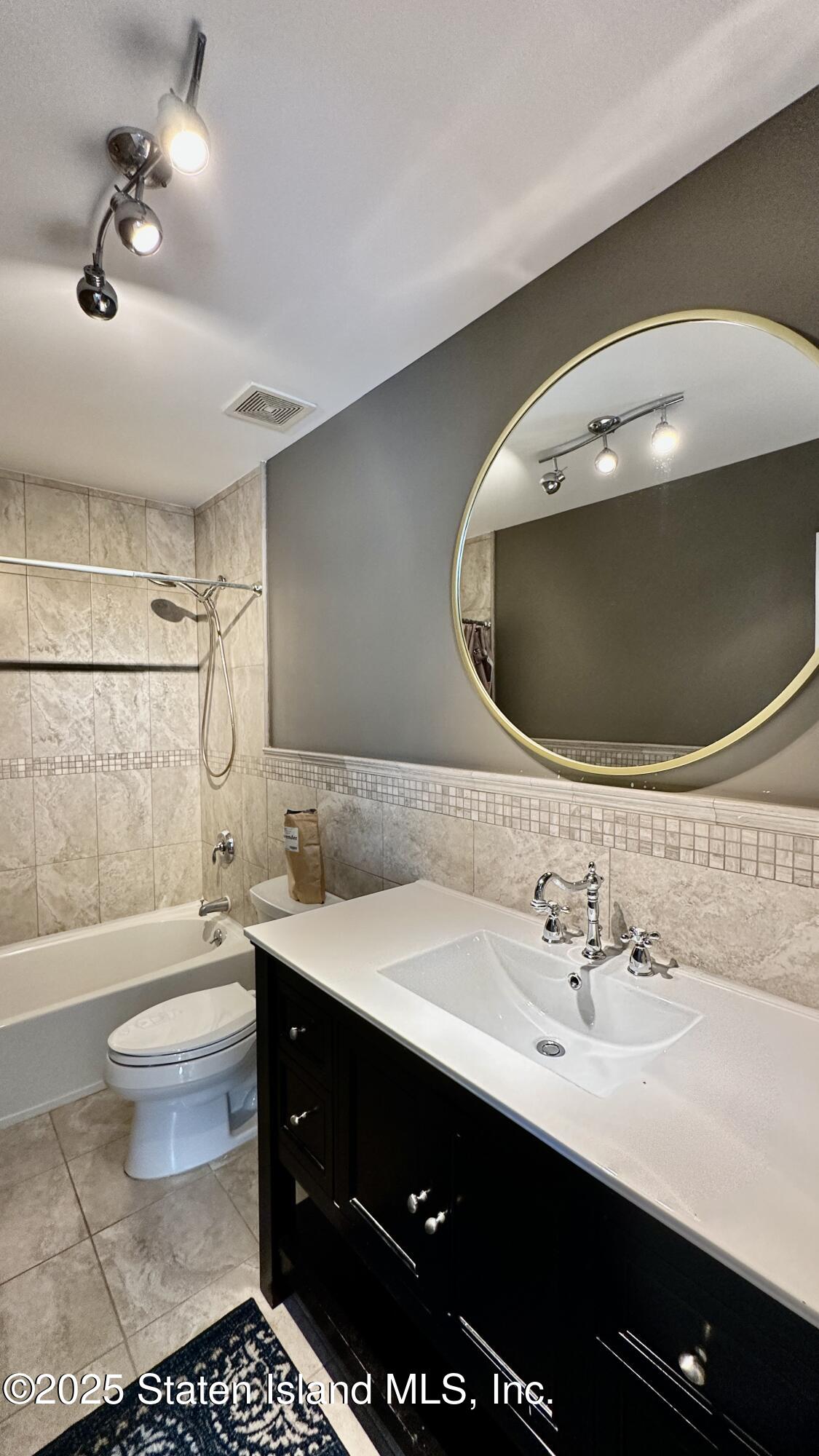 998 Annadale Road Staten Island, NY 10312 - Photo 22 of 46 a bathroom with a sink and a mirror