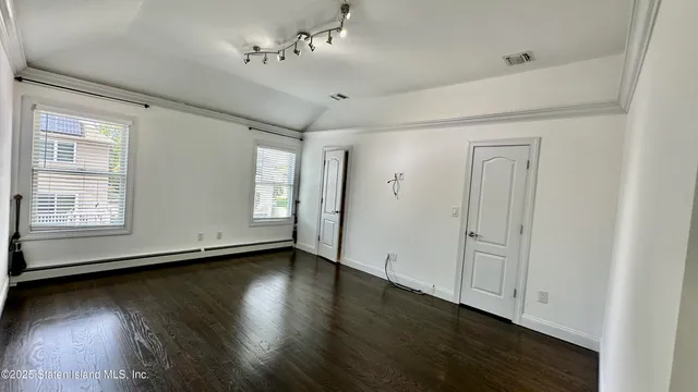 a view of a livingroom with wooden floor and a window