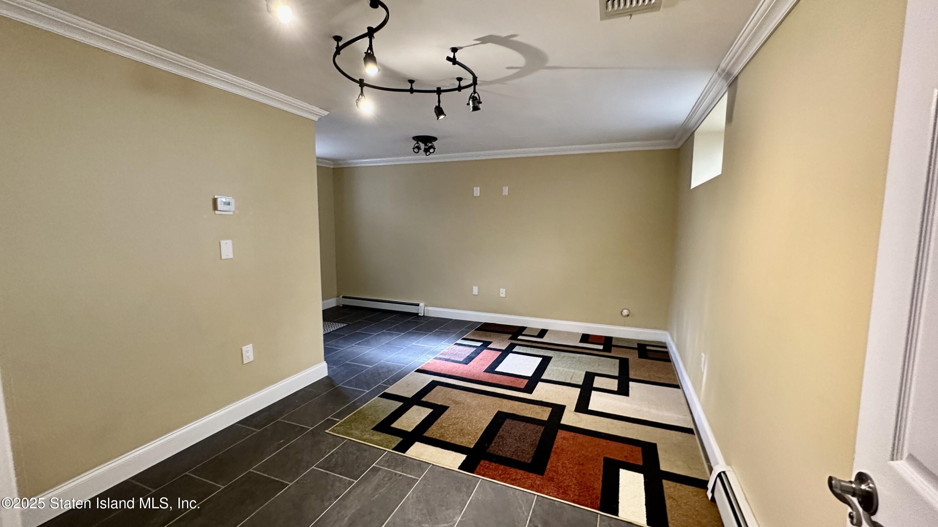 998 Annadale Road Staten Island, NY 10312 - Photo 31 of 46 a view of a room with furniture and wooden floor