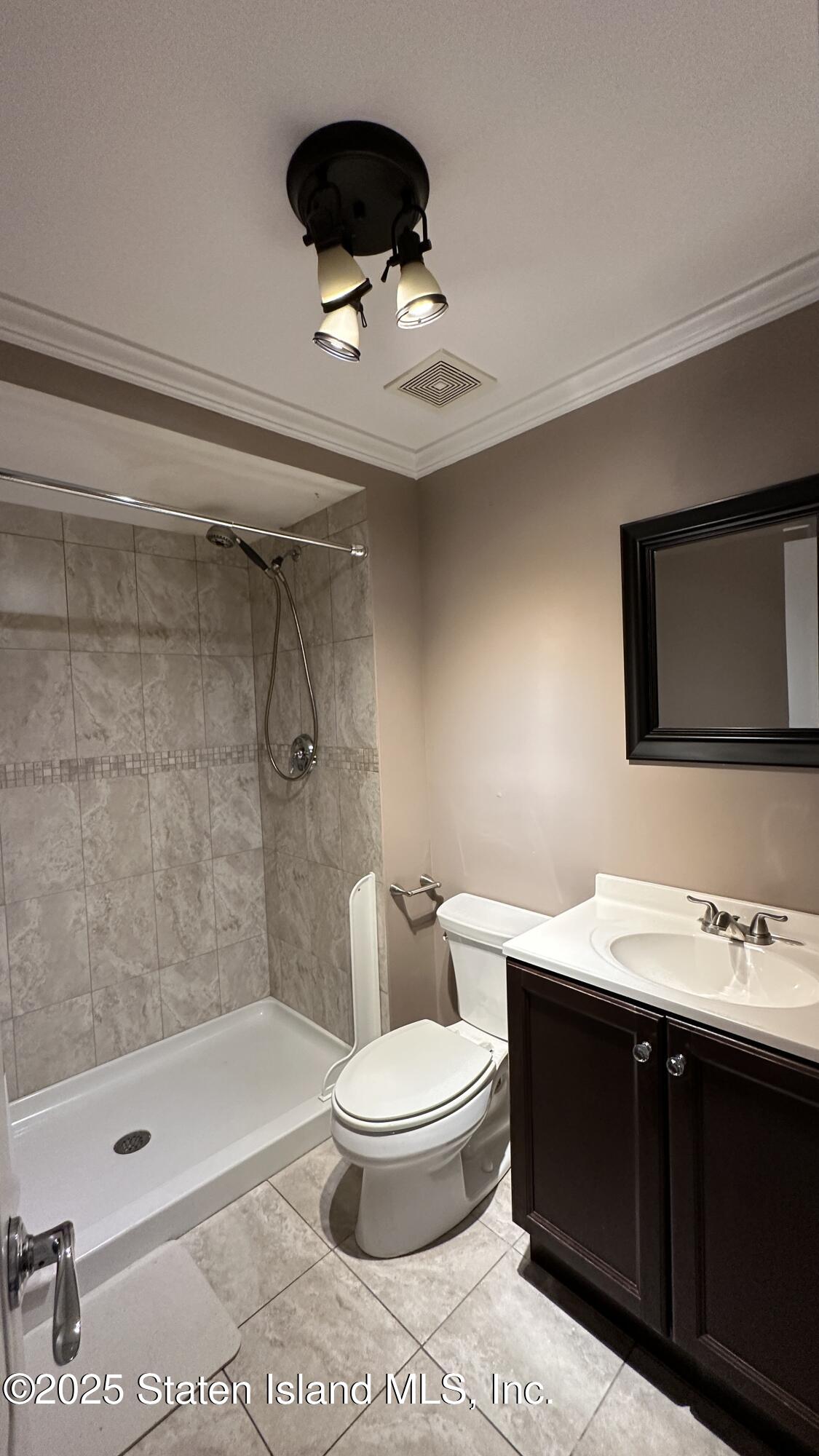 998 Annadale Road Staten Island, NY 10312 - Photo 33 of 46 a bathroom with a sink a toilet and shower