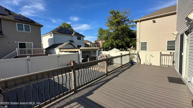 a view of a house with wooden deck