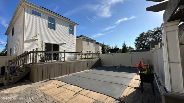 a view of balcony with wooden floor and seating space