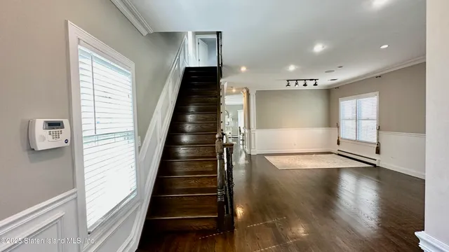 a view of an entryway with wooden floor