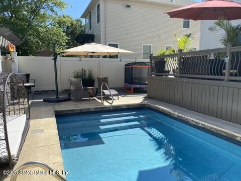 998 Annadale Road Staten Island, NY 10312 - Photo 42 of 46 a view of a patio with a table and chairs under an umbrella