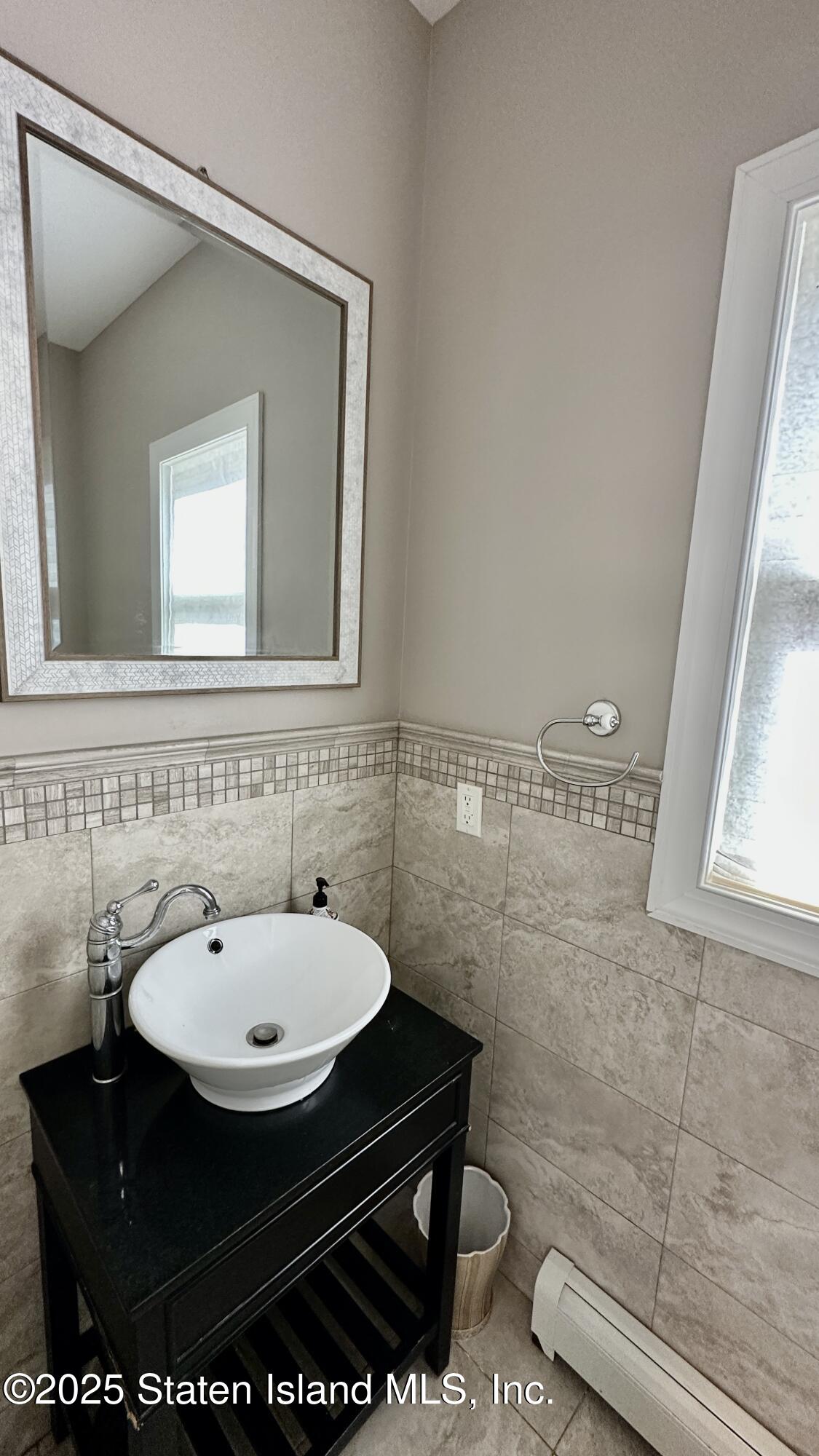 998 Annadale Road Staten Island, NY 10312 - Photo 10 of 46 a bathroom with a sink and a mirror
