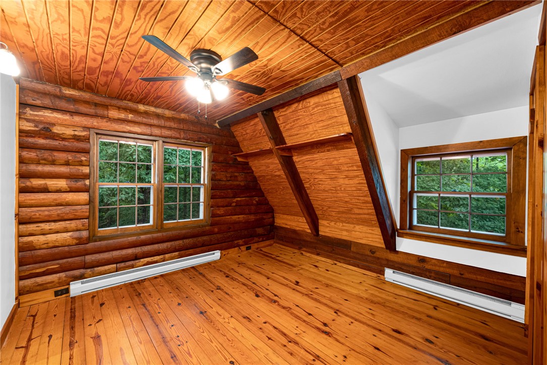 237 Spring Valley Road Liberty, SC 29657 - Photo 15 of 50 Natural wood textures define this inviting room, complete with a ceiling fan for comfort.