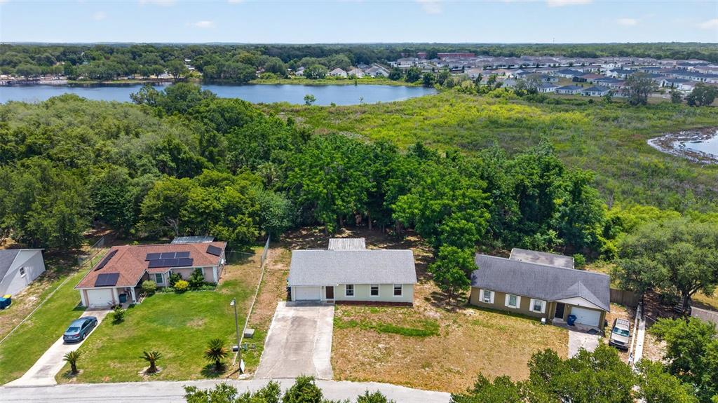 36 Bay Ridge Loop Mascotte, FL 34753 - Photo 3 of 32 an aerial view of a house with a garden and lake view