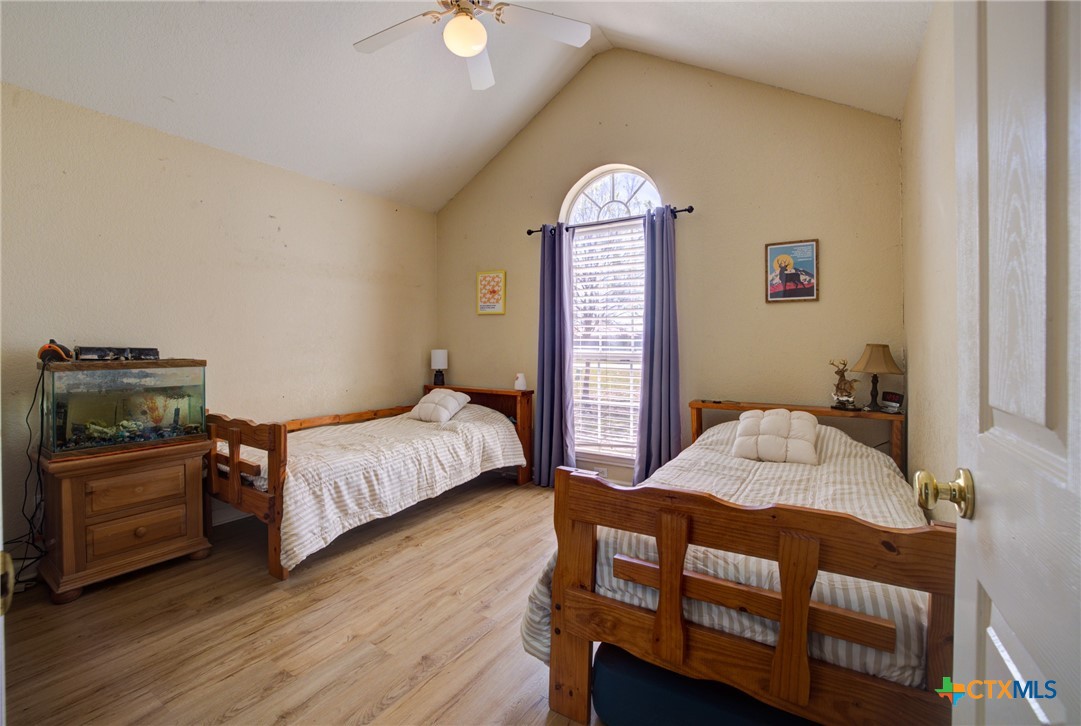 940 Cordova Loop Seguin, TX 78155 - Photo 14 of 32 a bedroom with a bed and wooden floor