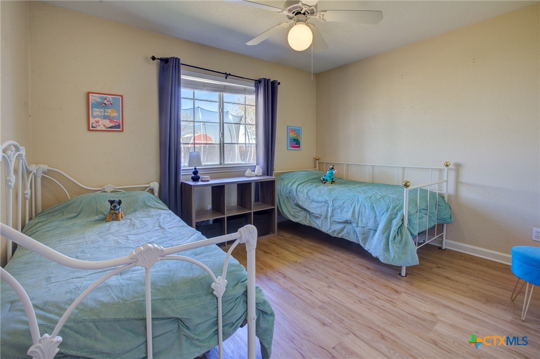 940 Cordova Loop Seguin, TX 78155 - Photo 16 of 32 a bedroom with a bed and wooden floor