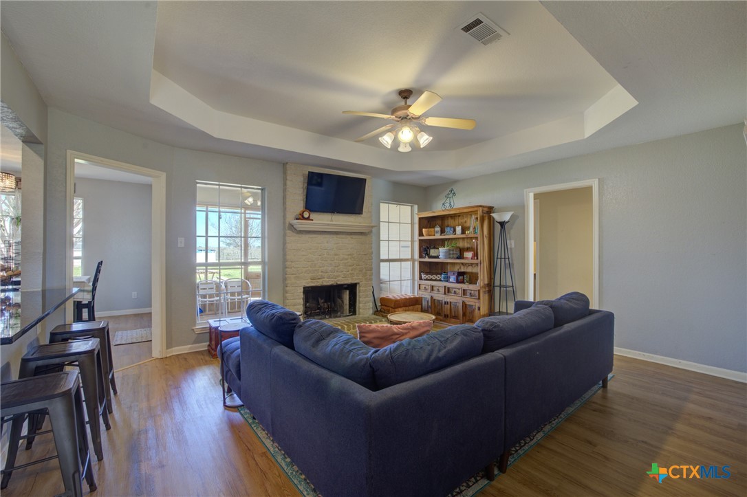 940 Cordova Loop Seguin, TX 78155 - Photo 7 of 32 a living room with furniture a fireplace and a flat screen tv