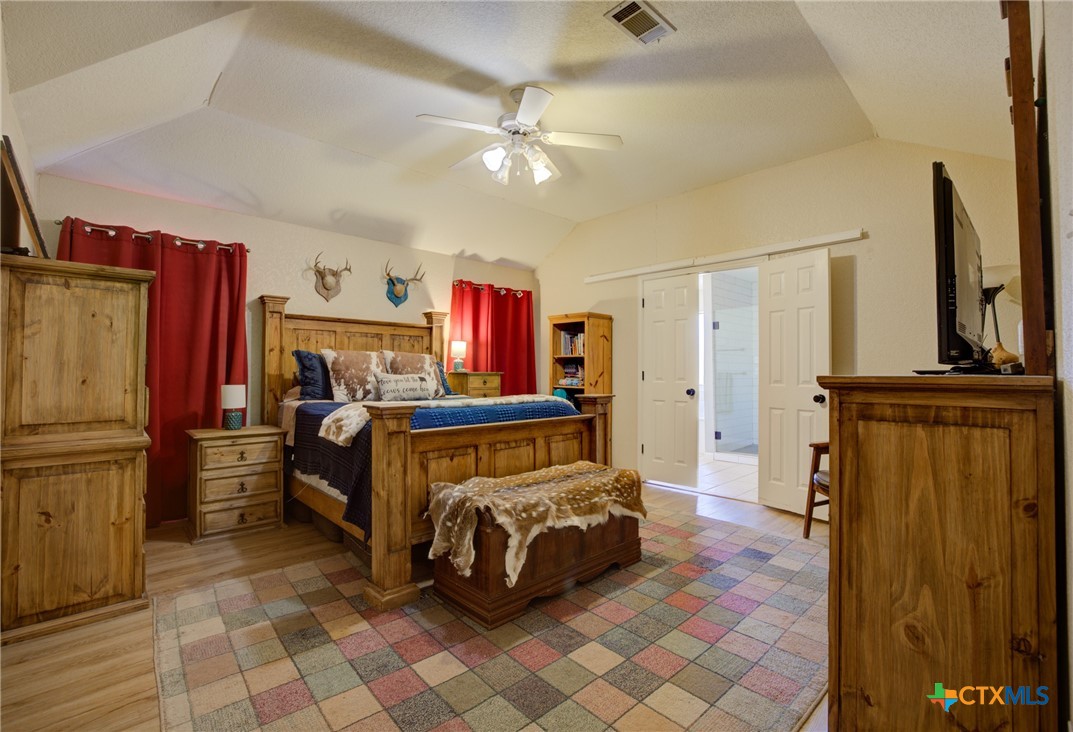 940 Cordova Loop Seguin, TX 78155 - Photo 9 of 32 a bedroom with furniture and a flat screen tv