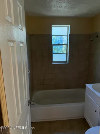 a bathroom with a bathtub and a shower