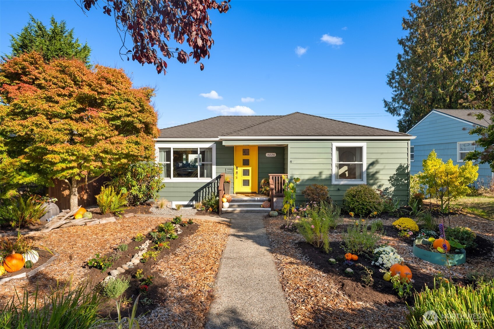4026 52nd Avenue Southwest Seattle, WA 98116 - Photo 1 of 37 a front view of a house with a garden