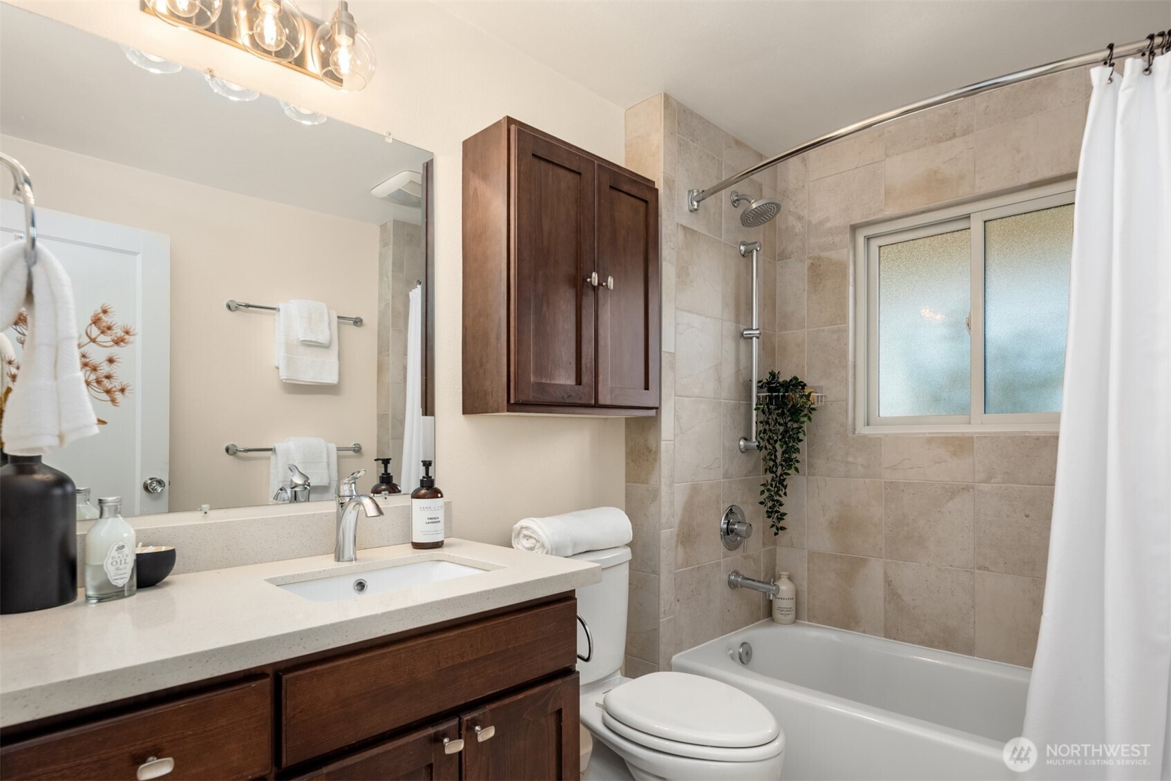 4026 52nd Avenue Southwest Seattle, WA 98116 - Photo 22 of 37 a bathroom with a bathtub shower sink vanity mirror and toilet