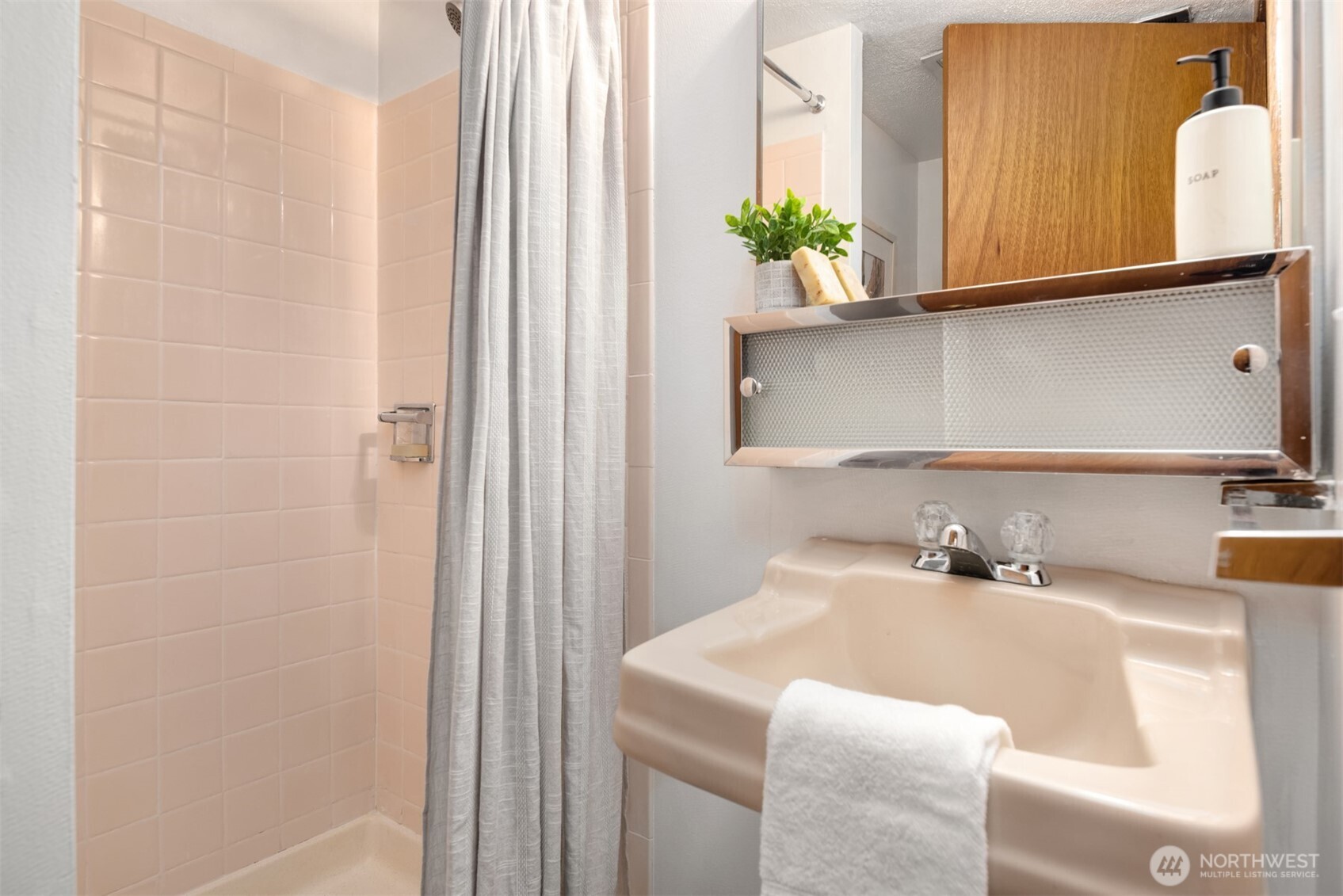4026 52nd Avenue Southwest Seattle, WA 98116 - Photo 24 of 37 a bathroom with a sink and a mirror