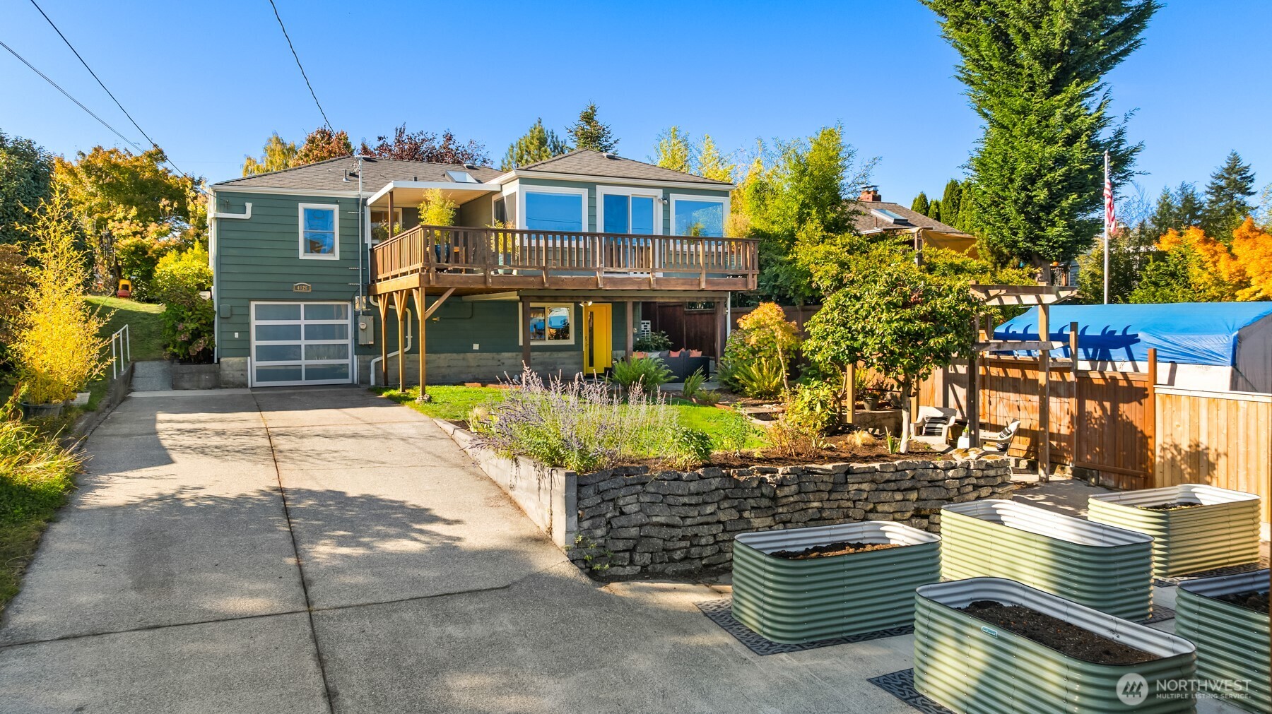 4026 52nd Avenue Southwest Seattle, WA 98116 - Photo 34 of 37 a front view of a house with a garden