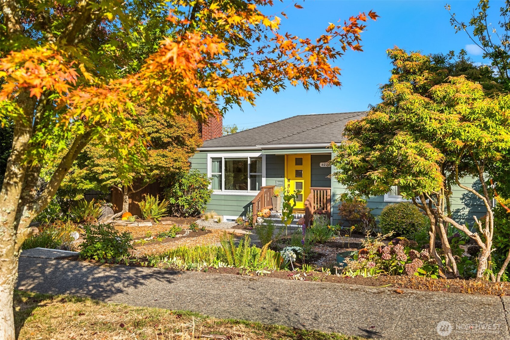 4026 52nd Avenue Southwest Seattle, WA 98116 - Photo 35 of 37 view of house with yard outdoor seating and covered with green space