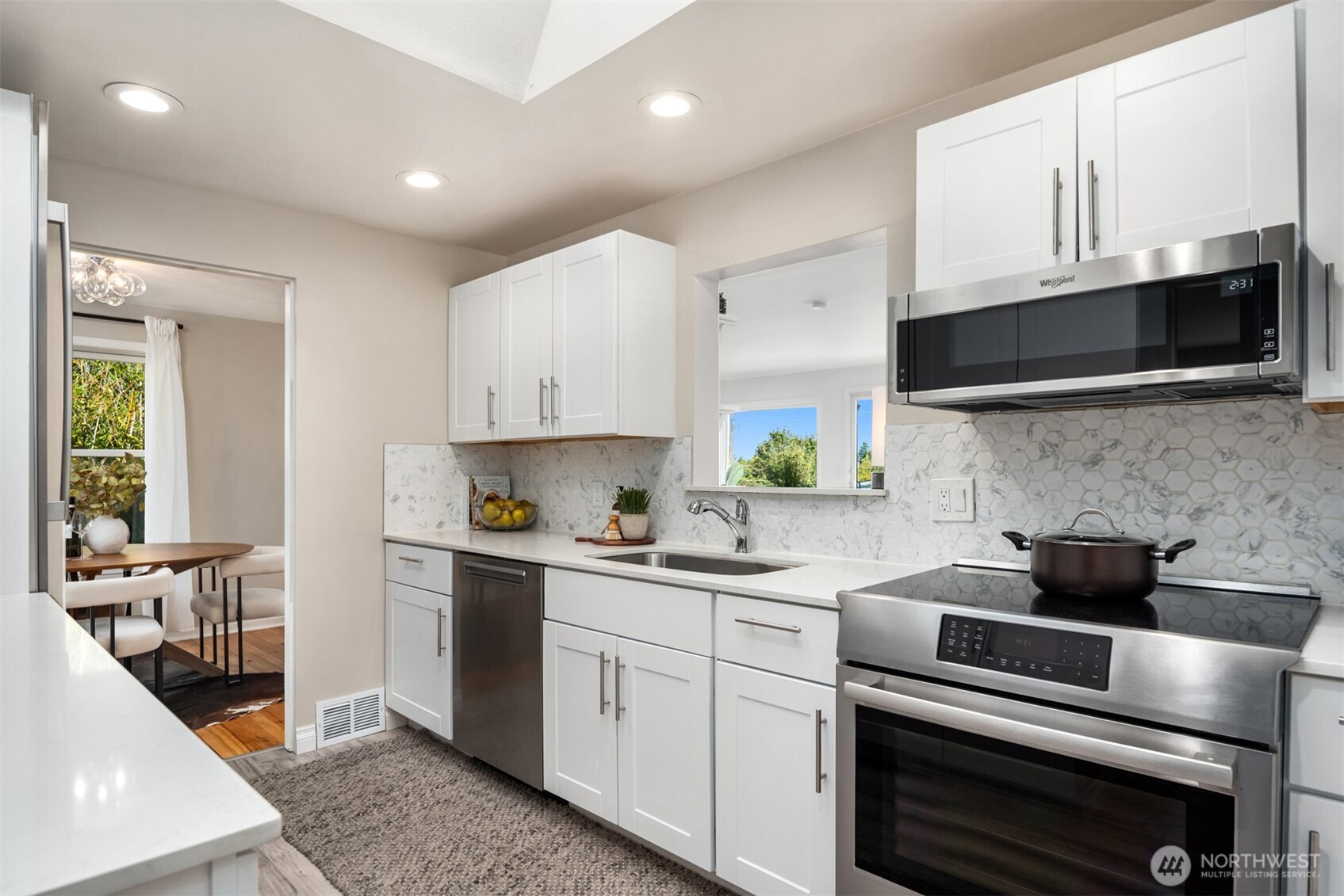 4026 52nd Avenue Southwest Seattle, WA 98116 - Photo 8 of 37 a kitchen with cabinets stainless steel appliances a sink and a stove