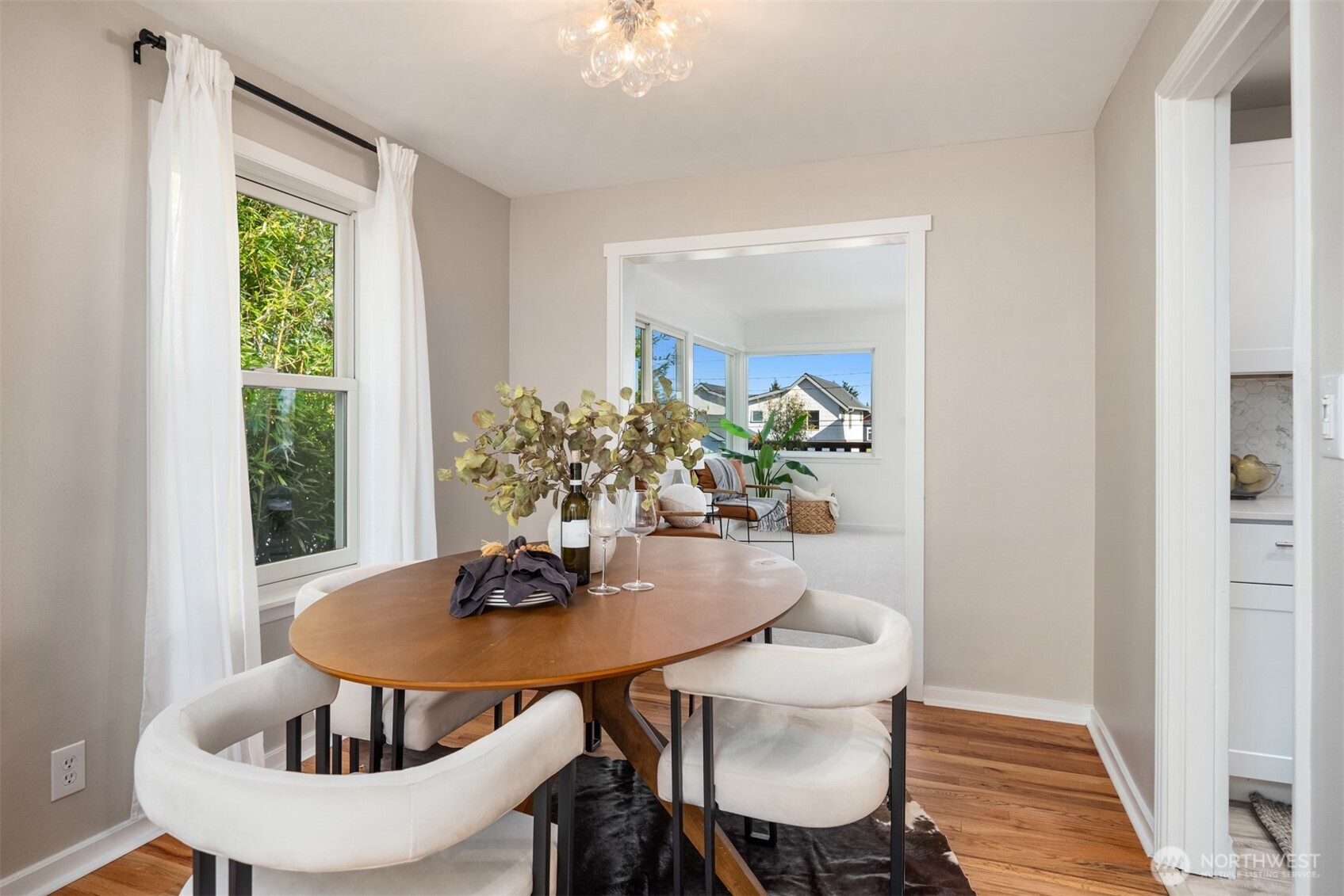 4026 52nd Avenue Southwest Seattle, WA 98116 - Photo 10 of 37 a dining room with furniture and wooden floor
