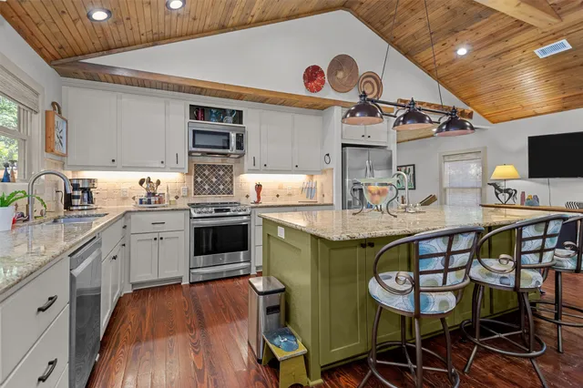 a kitchen with cabinets a sink and appliances