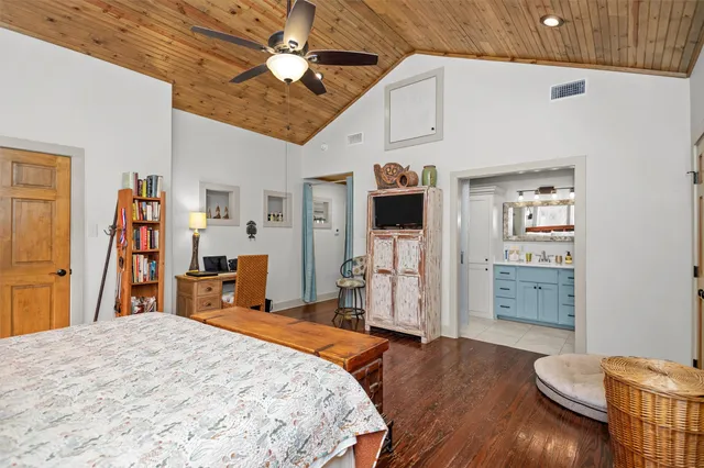 a bedroom with furniture and wooden floor