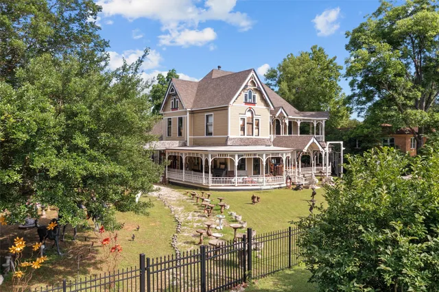 an aerial view of a house with swimming pool and garden