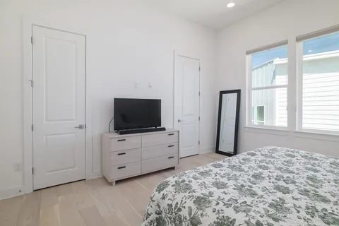 a bedroom with a bed and flat screen tv