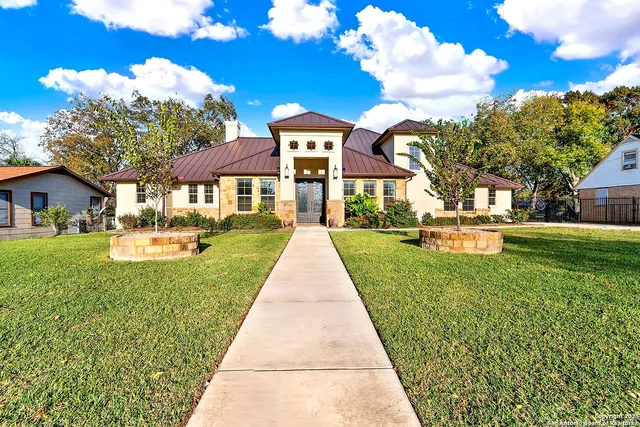 a front view of a house with garden