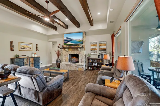 a living room with furniture fireplace and a large window