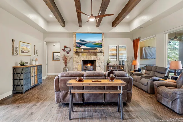 a living room with furniture a fireplace and a table