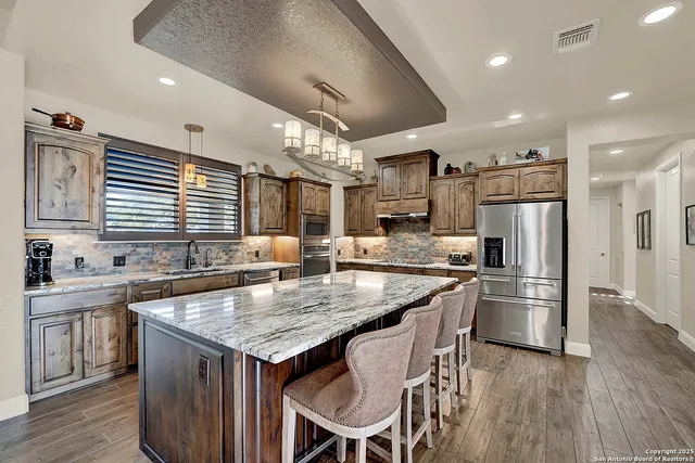 a kitchen with a stove a refrigerator and a sink