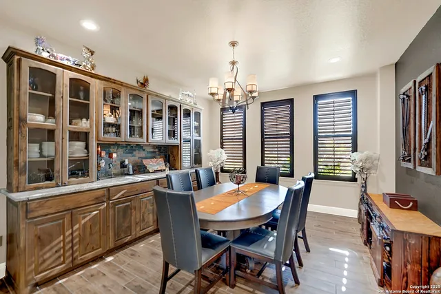 a view of a dining room with furniture and chandelier