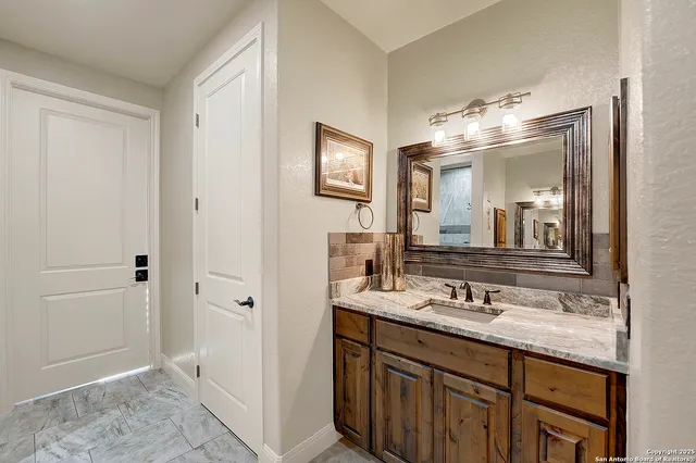 a bathroom with a sink and a mirror