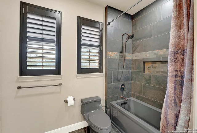 a bathroom with a granite countertop bathtub toilet and sink