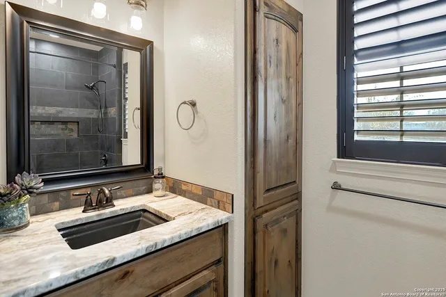 a bathroom with a sink and a mirror