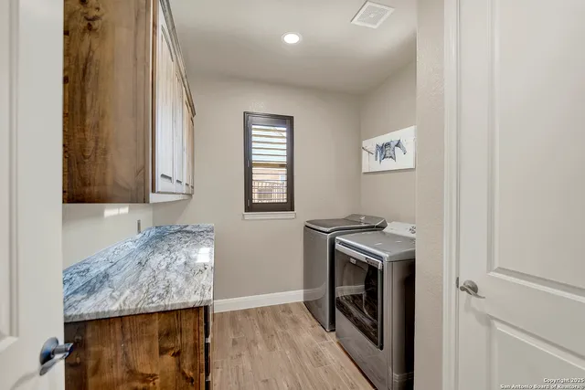 a kitchen with granite countertop cabinets stainless steel appliances and a counter space