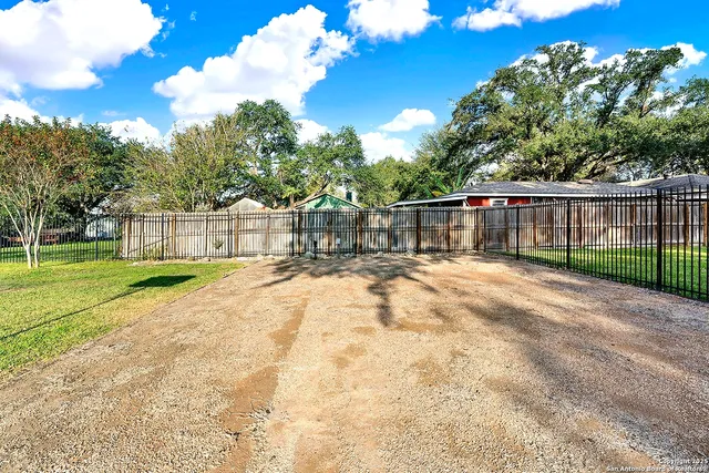 a dining room with furniture and a large window