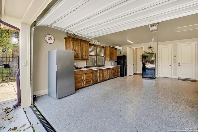a kitchen with stainless steel appliances a refrigerator and cabinets