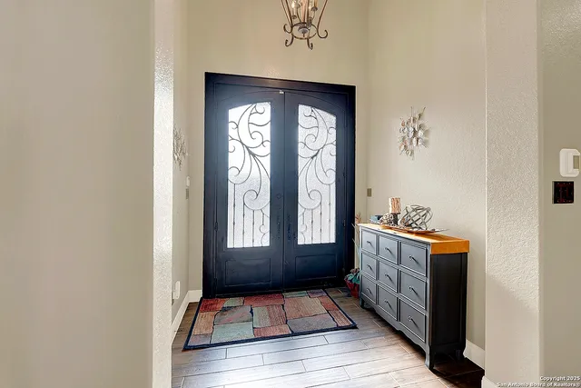 a view of an entryway with wooden floor and windows