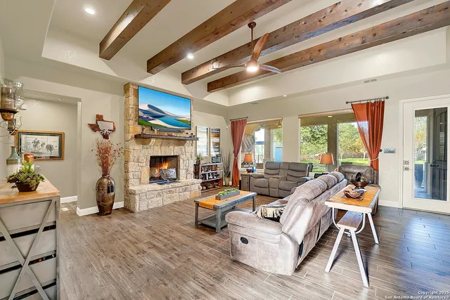 a living room with fireplace furniture and a wooden floor